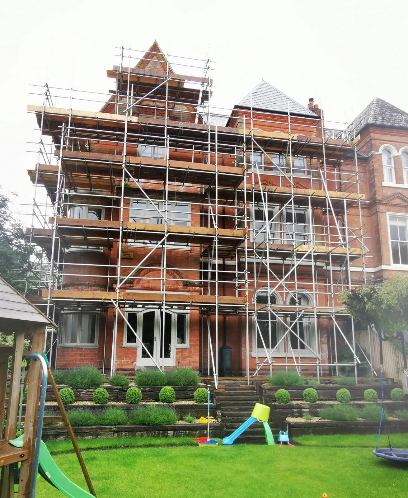 Multi-lift scaffold covering the full rear elevation of a large Victorian house
